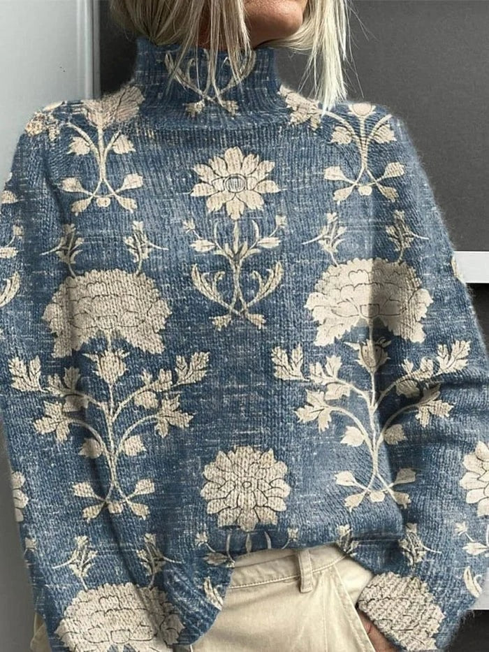 Jersey azul grisáceo de cuello alto con motivos florales y botánicos en color crema.