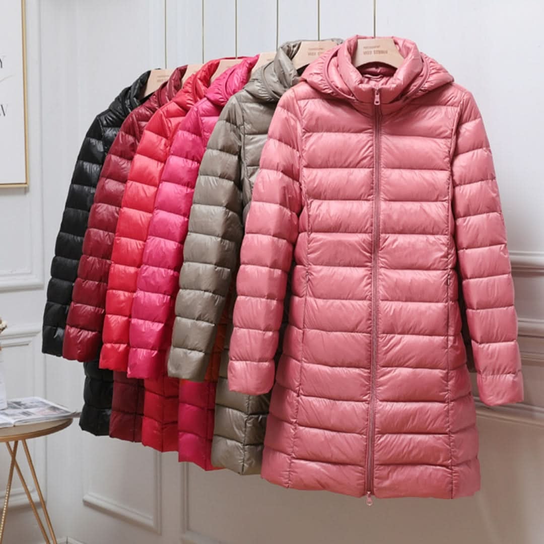 Abrigos acolchados largos con capucha en varios colores, con un modelo rosa al frente.