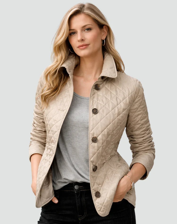 Chaqueta acolchada beige de corte entallado, con botones frontales y las manos dentro de los bolsillos.