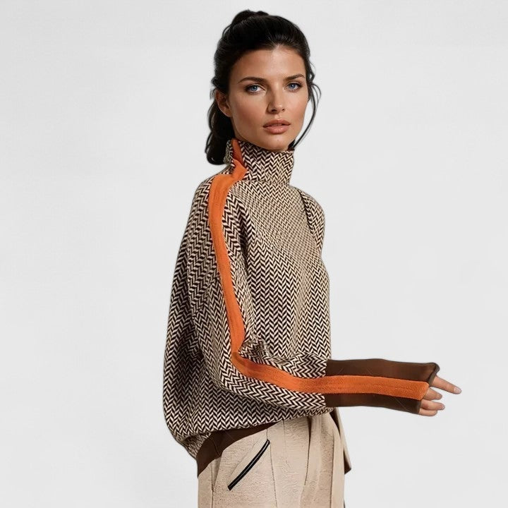 Jersey de cuello alto con estampado de espiga y rayas naranjas en contraste a lo largo de los hombros y las mangas, mostrado de perfil.