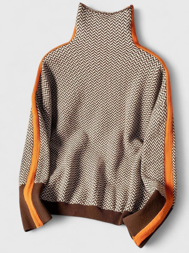 Jersey extendido sobre fondo claro, con cuello alto, estampado de espiga y rayas naranjas y marrones en los laterales de las mangas.