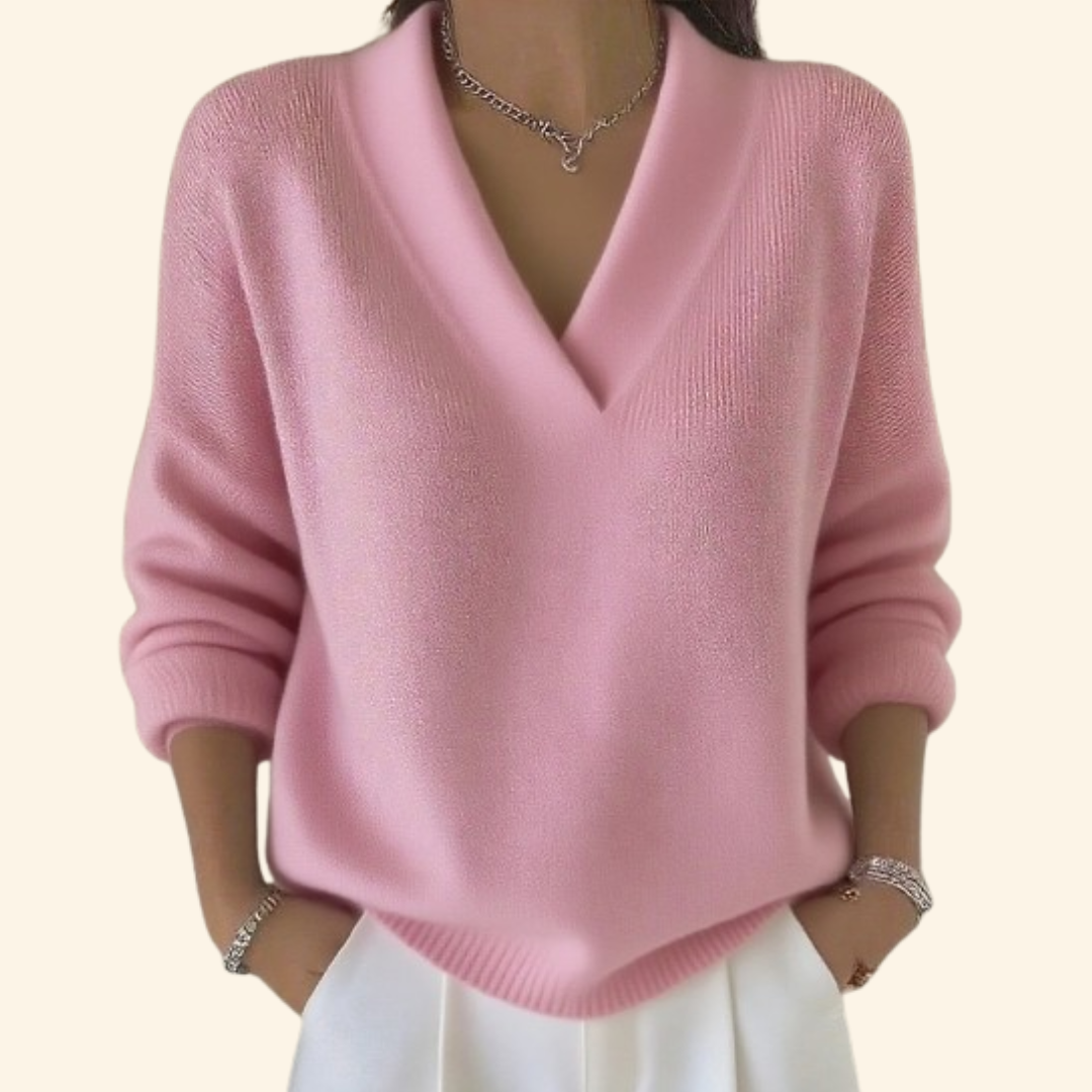 Jersey rosa de cuello en V con silueta holgada, mangas largas recogidas y acabado acanalado en el bajo.