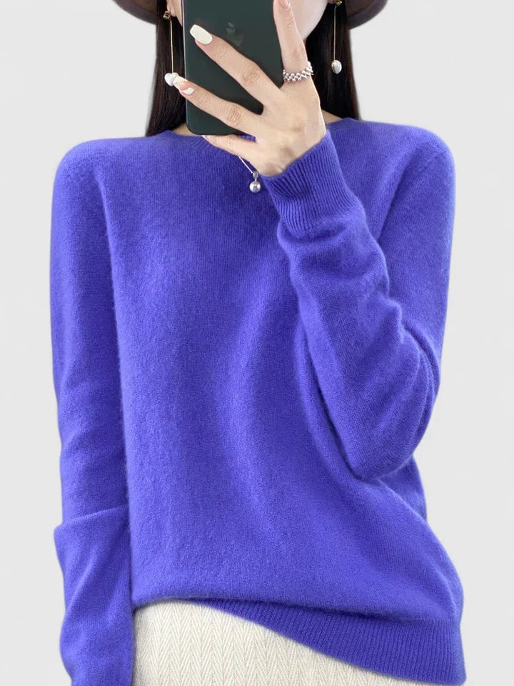Jersey azul violeta de silueta holgada sobre fondo claro, combinado con pantalón blanco.