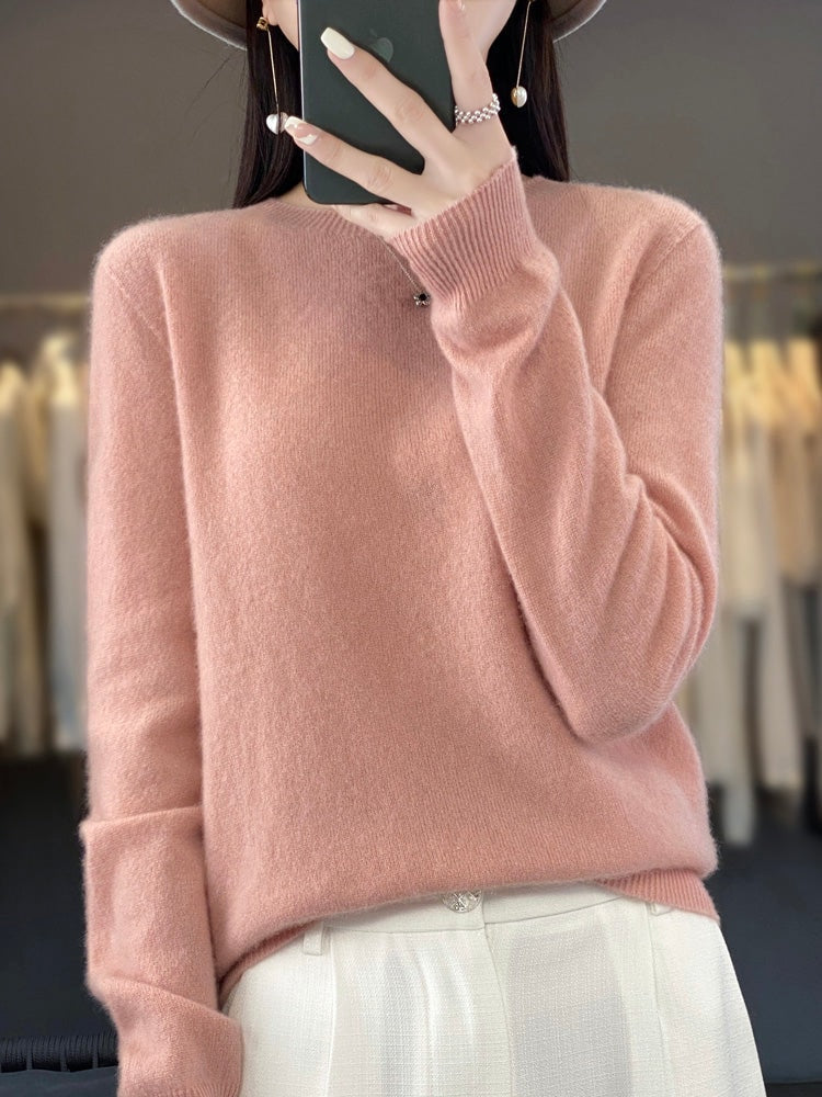 Jersey rosa empolvado con cuello redondo y mangas largas, combinado con pantalón blanco.