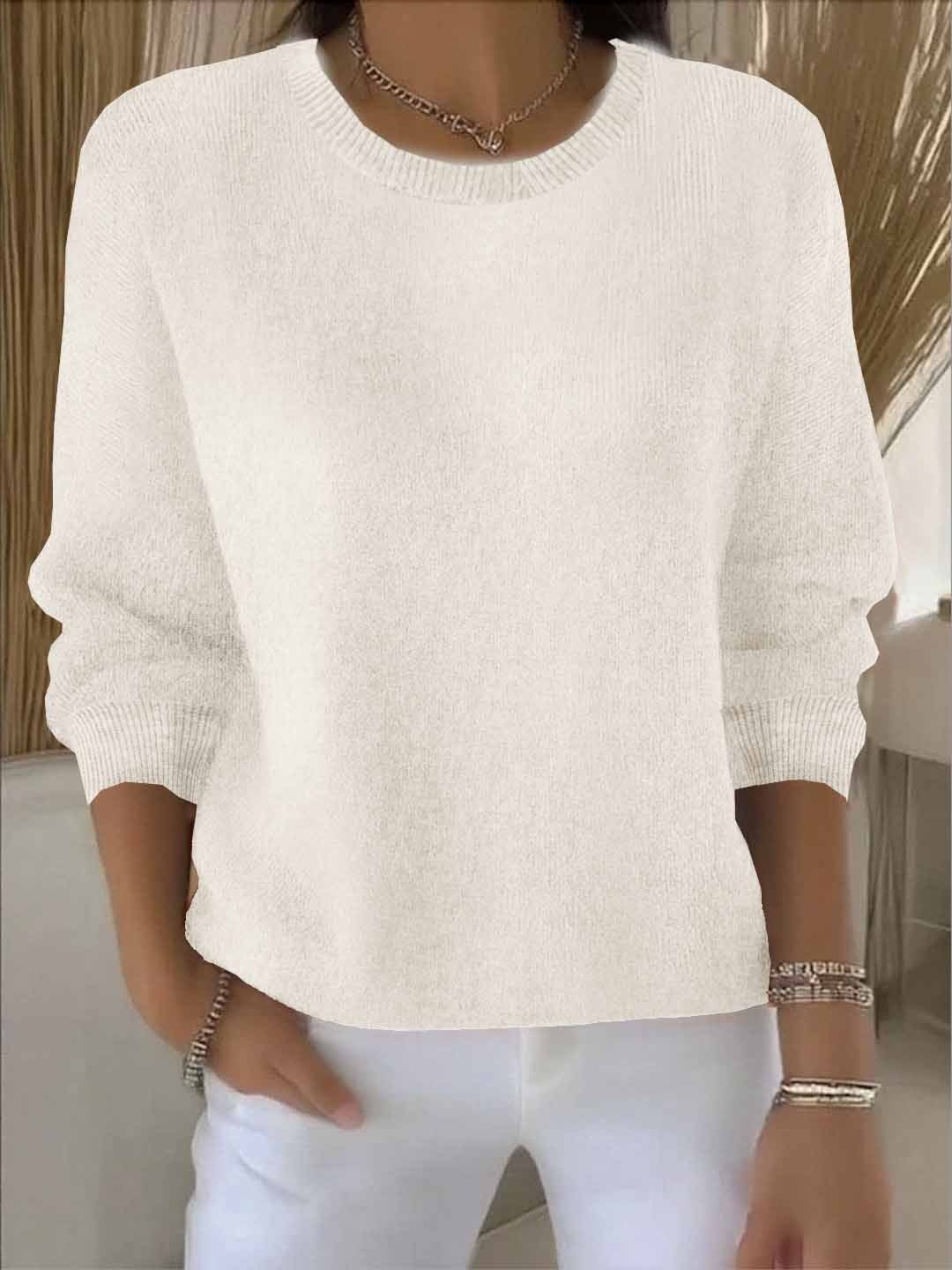 Jersey blanco roto de estilo relajado, con cuello redondo y mangas largas voluminosas.