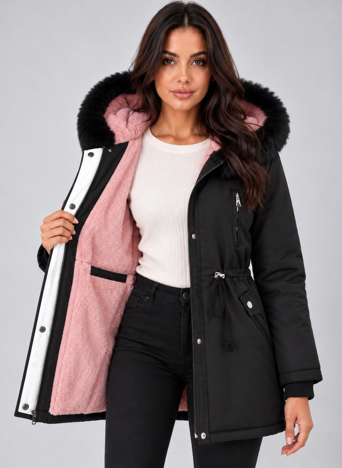 Parka negra abierta que muestra el interior de color rosa, la capucha con pelo sintético y el cierre frontal con broches.