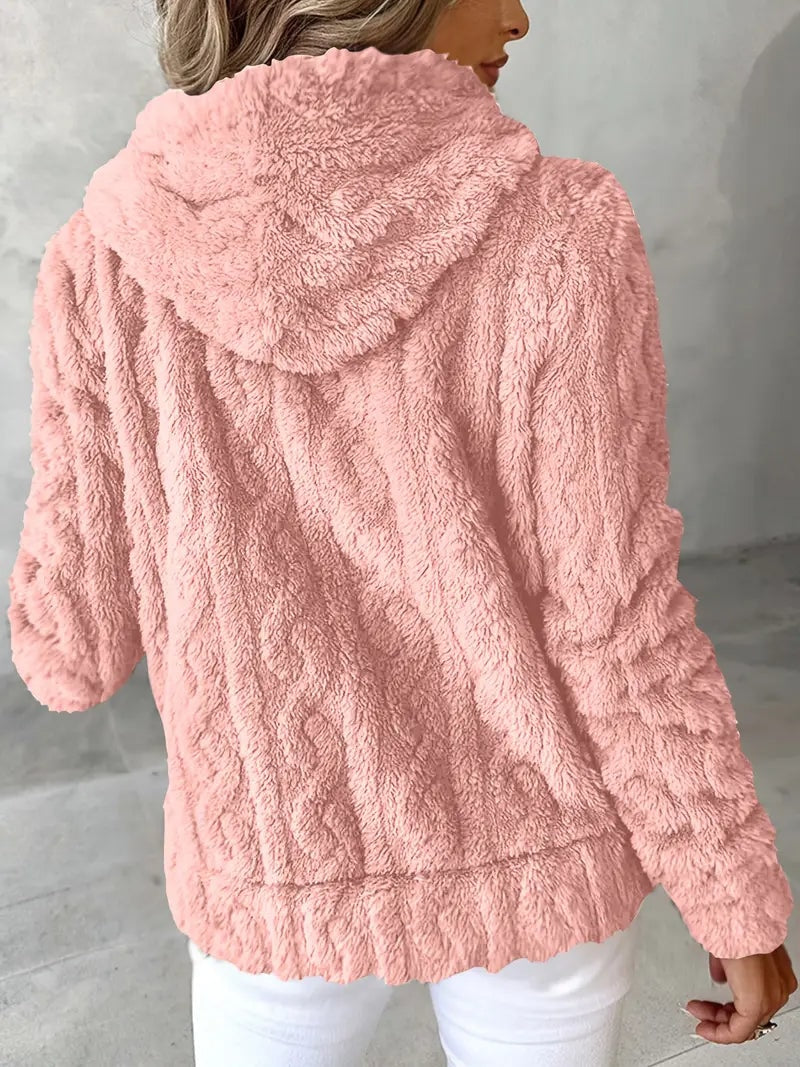 Vista trasera de la sudadera rosa, donde destacan la capucha y el bajo ligeramente fruncido.