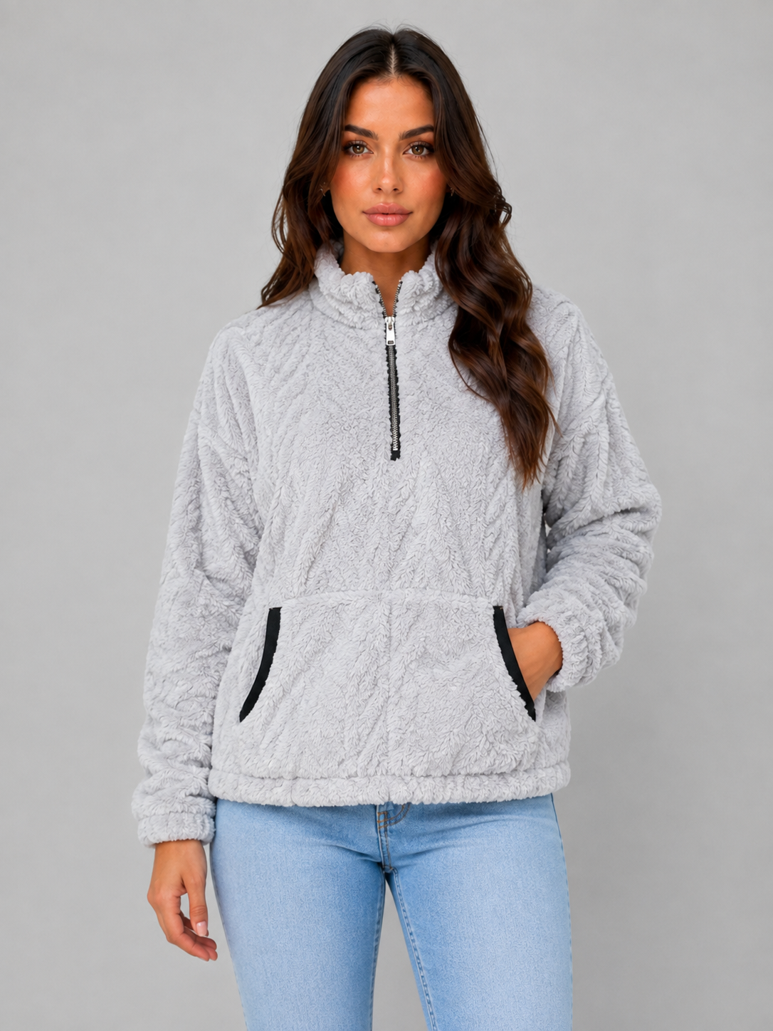 Sudadera gris claro de pelo con cuello alto, media cremallera y bolsillo delantero, vista de frente.