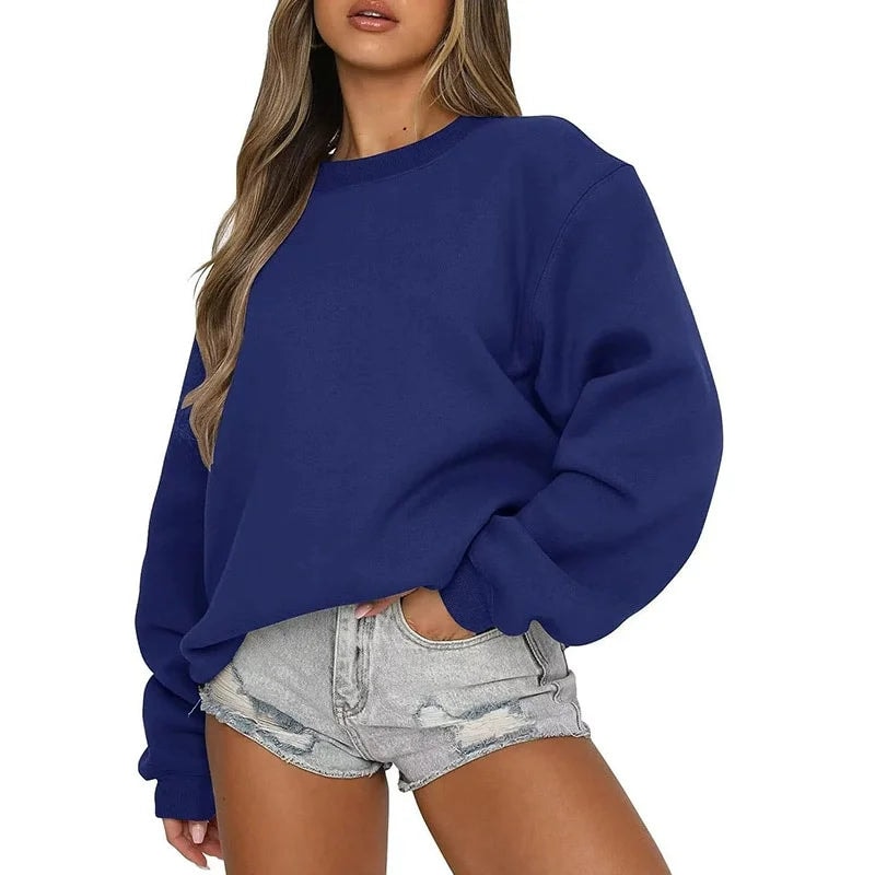 Sudadera oversize azul marino de corte relajado, llevada con shorts vaqueros claros.