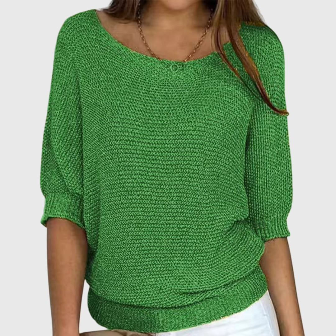 Suéter holgado verde de textura tejida, escote amplio y mangas tres cuartos.